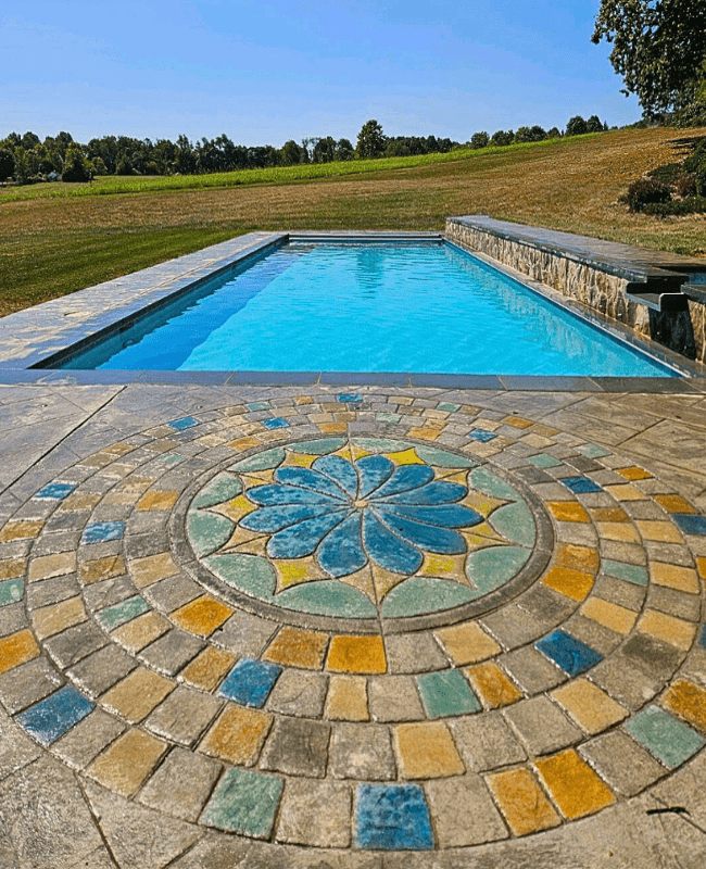 rectangular pool with custom deck and retaining wall