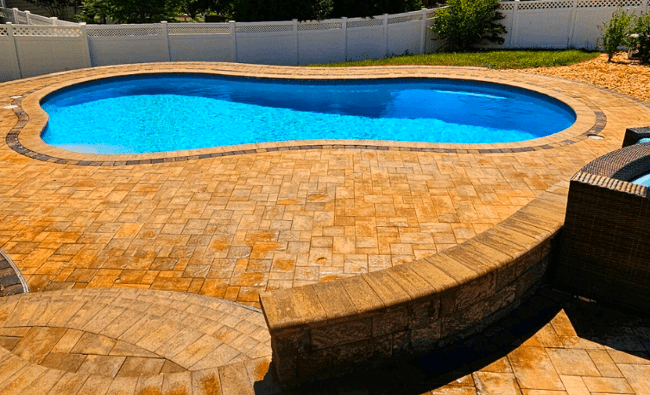 Haymarket va small backyard pool, very blue, with brown paver deck